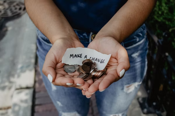 a women holding a couple of coins 