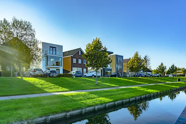 a lake site real estate with lots of greenery 