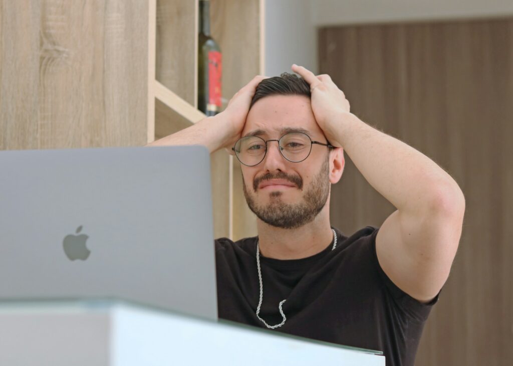 a man holding his head 